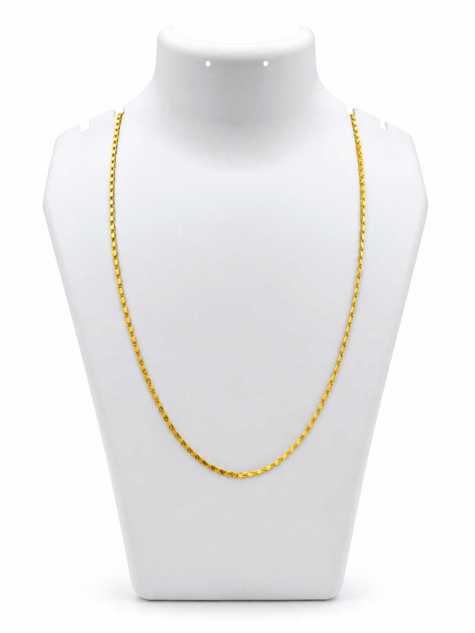 Slender golden chain necklace with repeating small geometric links displayed in a U shape and on a white necklace bust. - bhavmayi