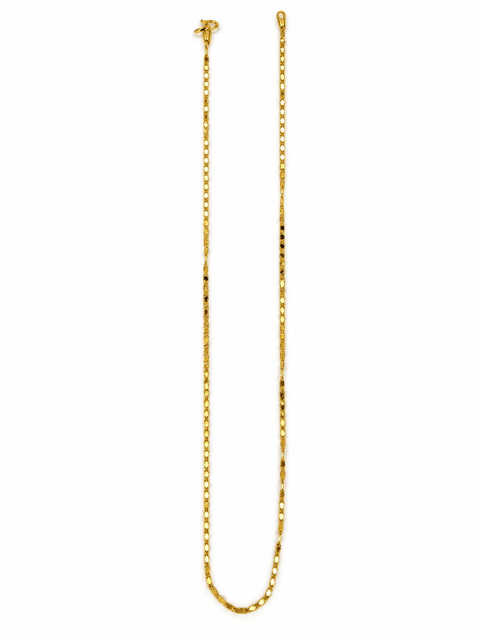 Slender golden chain necklace with repeating small geometric links displayed in a U shape and on a white necklace bust. - bhavmayi