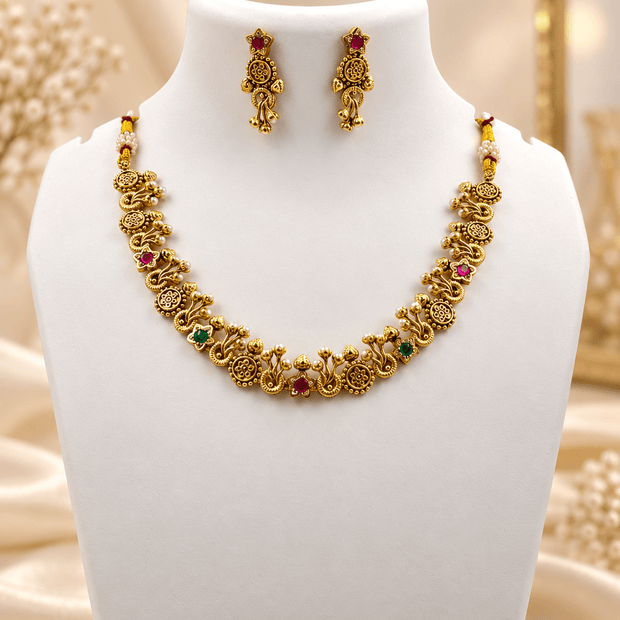 Bhavmayi traditional golden-toned necklace and matching earrings with floral motifs and red and green accent details